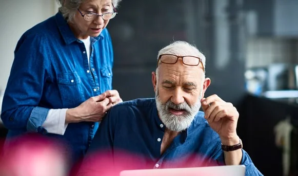 Man and woman looking at a laptop