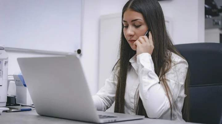 Man and woman looking at a laptop